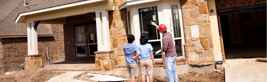 couple discussing new home construction with contractor